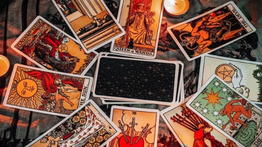 Mum ışığında tarot kartlarını açan eller, masada Türk kahvesi fincanları ve arka planda Ankara şehir manzarası.